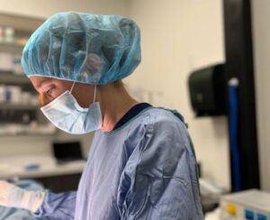 Surgeon in mask, scrubs Surgeon in mask, scrubs