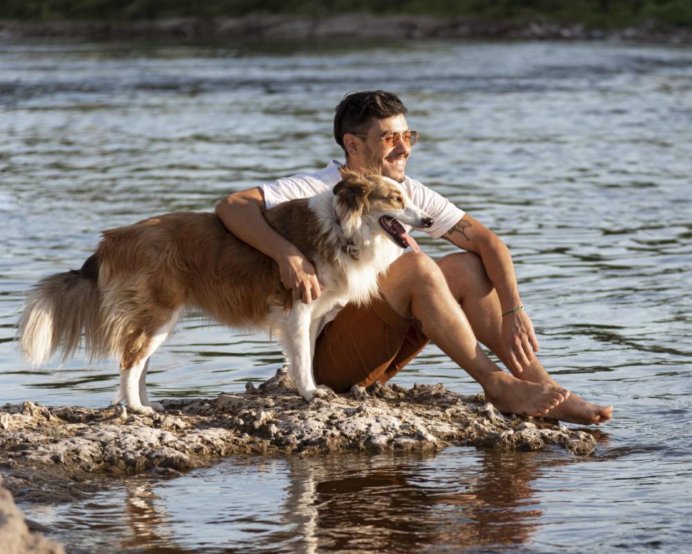 Man and dog on rock. Man and dog on rock.